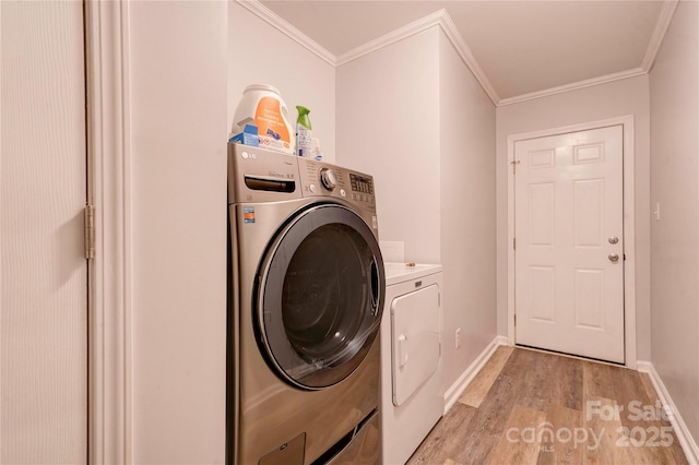 812 Kings Rd, Shelby, NC 28150 - laundry room featuring washing machine and dryer, light wood-style flooring, and ornamental molding