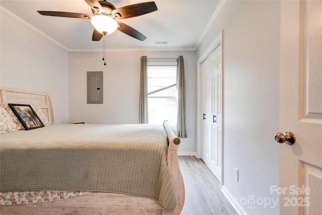 812 Kings Rd, Shelby, NC 28150 - bedroom with electric panel, light wood finished floors, crown molding, a closet, and ceiling fan