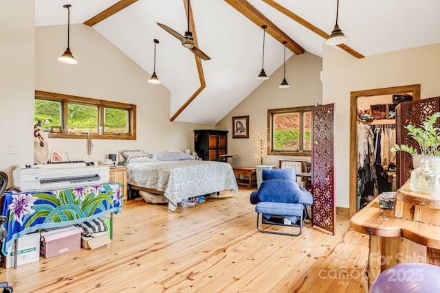 43 Dillingham Estates Trl, Swannanoa, NC 28778 - bedroom featuring beamed ceiling, hardwood / wood-style floors, high vaulted ceiling, multiple windows, and a walk in closet