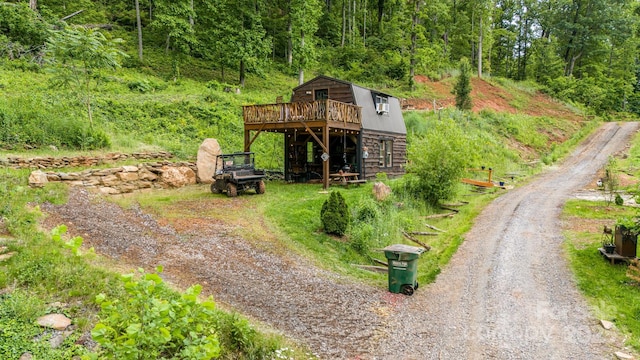43 Dillingham Estates Trl, Swannanoa, NC 28778 - view of front of house with dirt driveway, a wooden deck, and a wooded view