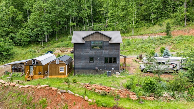 43 Dillingham Estates Trl, Swannanoa, NC 28778 - back of house featuring central air condition unit, metal roof, and a forest view