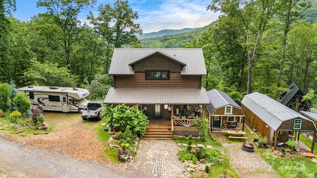 43 Dillingham Estates Trl, Swannanoa, NC 28778 - rustic home featuring covered porch, metal roof, a mountain view, and a forest view