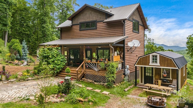 43 Dillingham Estates Trl, Swannanoa, NC 28778 - view of front of house featuring faux log siding, a porch, metal roof, and a mountain view