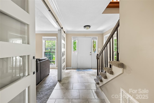 7528 Red Oak Ln, Charlotte, NC 28226 - foyer featuring crown molding, carpet floors, a textured ceiling, stairs, and a barn door
