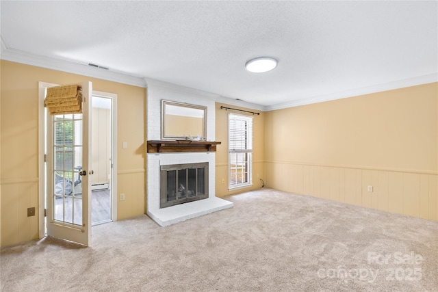 7528 Red Oak Ln, Charlotte, NC 28226 - unfurnished living room featuring ornamental molding, healthy amount of natural light, carpet, wainscoting, and a brick fireplace