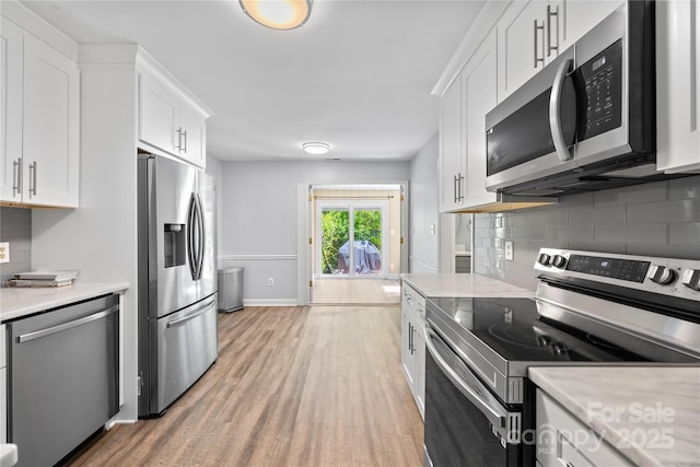 7528 Red Oak Ln, Charlotte, NC 28226 - kitchen with appliances with stainless steel finishes, light countertops, decorative backsplash, and white cabinetry