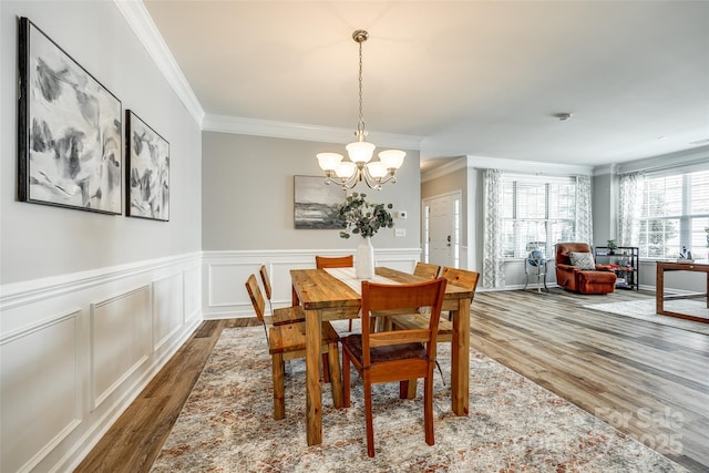 714 Deerbrook Ln, Tega Cay, SC 29708 - dining space featuring wood finished floors, crown molding, a chandelier, and a wainscoted wall