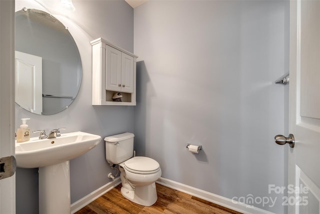 714 Deerbrook Ln, Tega Cay, SC 29708 - bathroom featuring wood finished floors, toilet, baseboards, and a sink