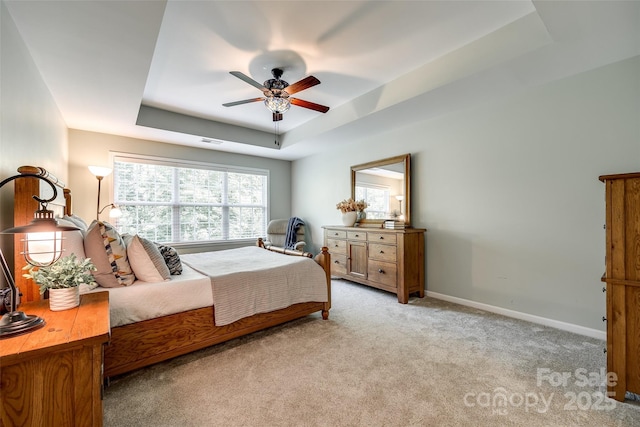 714 Deerbrook Ln, Tega Cay, SC 29708 - bedroom featuring a raised ceiling, light colored carpet, baseboards, and ceiling fan