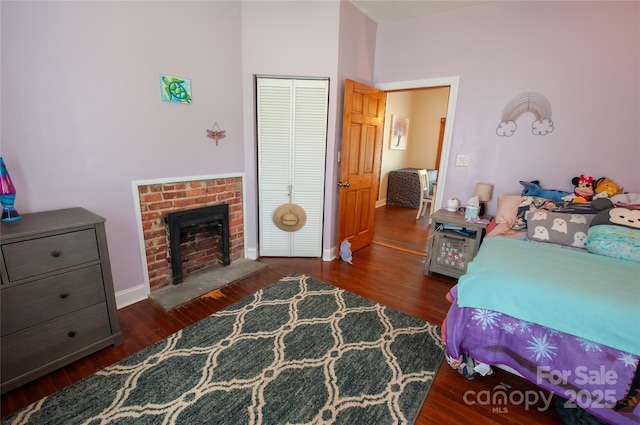 505 S Eastway Dr, Troutman, NC 28166 - bedroom featuring wood finished floors, a closet, and a fireplace