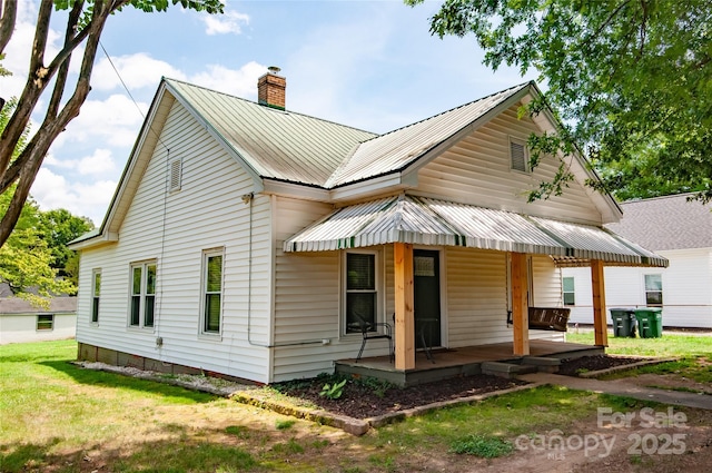 505 S Eastway Dr, Troutman, NC 28166 - view of front of house with a porch, a chimney, and a metal roof