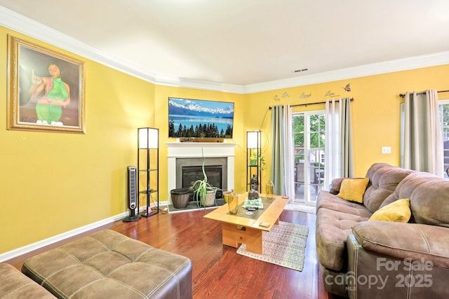 14018 Drake Watch Ln, Charlotte, NC 28262 - living room with dark wood finished floors, crown molding, a glass covered fireplace, and baseboards