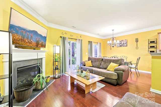 14018 Drake Watch Ln, Charlotte, NC 28262 - living area with baseboards, a chandelier, wood finished floors, a glass covered fireplace, and ornamental molding