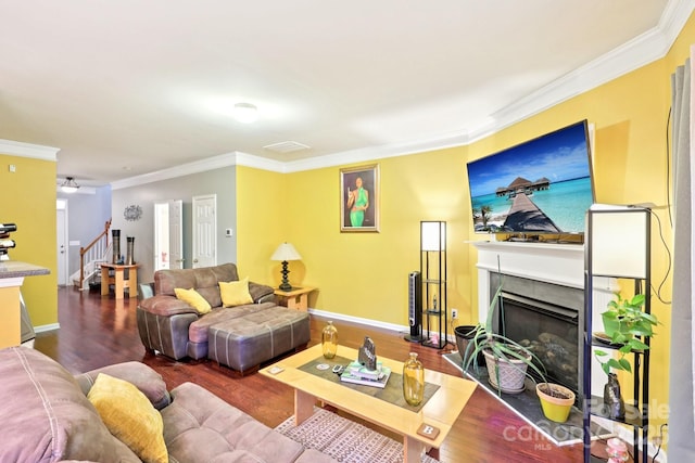 14018 Drake Watch Ln, Charlotte, NC 28262 - living area with stairway, a fireplace with raised hearth, crown molding, wood finished floors, and baseboards