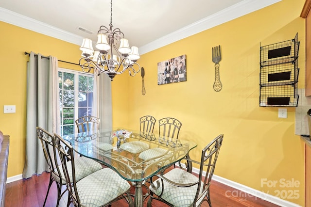 14018 Drake Watch Ln, Charlotte, NC 28262 - dining space with a chandelier, wood finished floors, baseboards, and ornamental molding