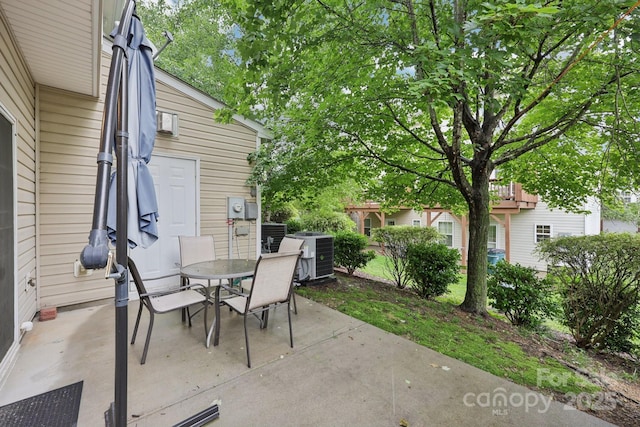 14018 Drake Watch Ln, Charlotte, NC 28262 - view of patio / terrace featuring central AC unit and outdoor dining space