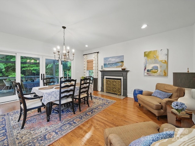 4644 Snow Dr, Harrisburg, NC 28075 - dining room featuring a chandelier, wood finished floors, recessed lighting, a fireplace with flush hearth, and baseboards