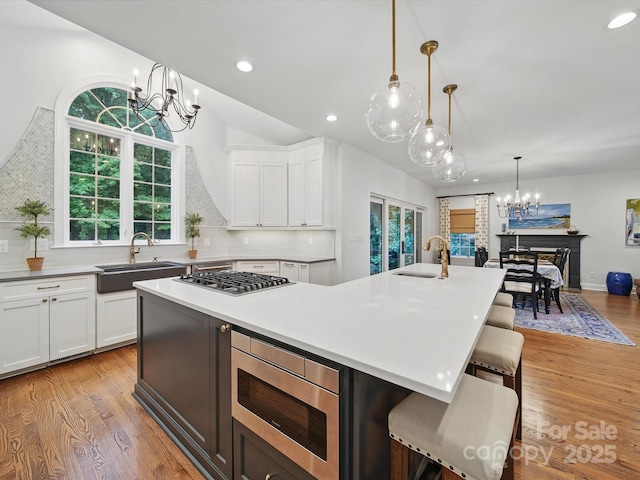 4644 Snow Dr, Harrisburg, NC 28075 - kitchen featuring a chandelier, a sink, appliances with stainless steel finishes, a kitchen island with sink, and recessed lighting