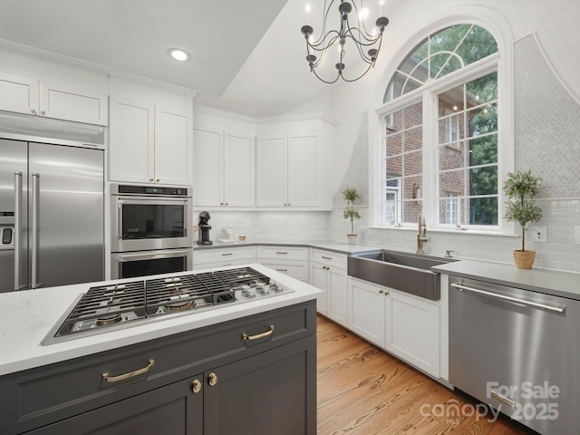 4644 Snow Dr, Harrisburg, NC 28075 - kitchen with stainless steel appliances, a sink, white cabinets, light countertops, and recessed lighting