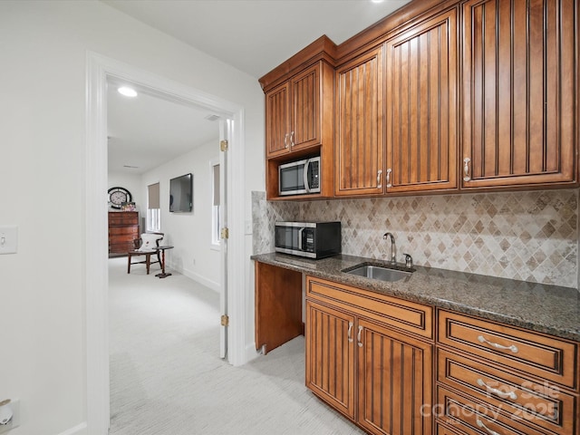 4644 Snow Dr, Harrisburg, NC 28075 - kitchen with a sink, stainless steel microwave, baseboards, and light colored carpet