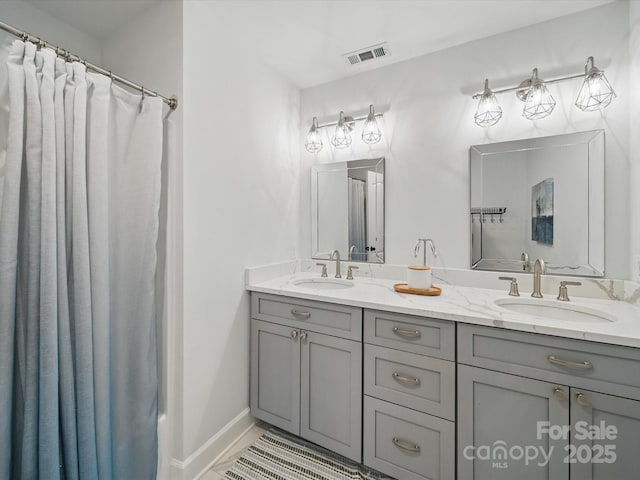 4644 Snow Dr, Harrisburg, NC 28075 - full bath featuring double vanity, a shower with shower curtain, and baseboards