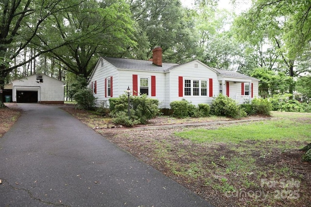 1270 N Enochville Ave, China Grove, NC 28023 - single story home featuring an outbuilding, a garage, a chimney, driveway, and view of scattered trees
