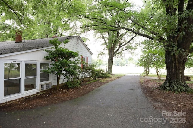 1270 N Enochville Ave, China Grove, NC 28023 - view of home's exterior with a chimney, roof with shingles, and driveway
