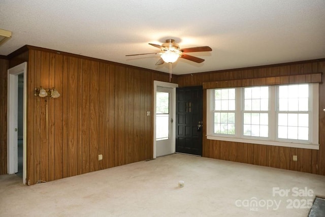 1270 N Enochville Ave, China Grove, NC 28023 - unfurnished living room with wooden walls, ceiling fan, carpet flooring, and a textured ceiling