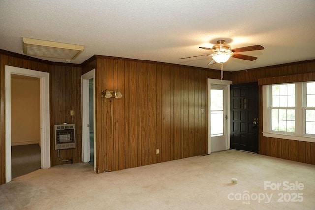 1270 N Enochville Ave, China Grove, NC 28023 - spare room with heating unit, wooden walls, carpet flooring, a ceiling fan, and a textured ceiling