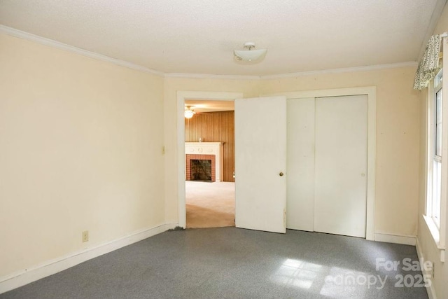 1270 N Enochville Ave, China Grove, NC 28023 - unfurnished bedroom featuring a fireplace, ornamental molding, and a closet
