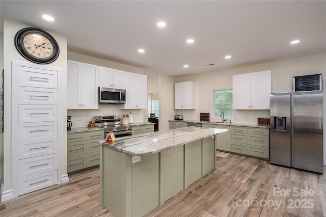 3103 Richview Dr, Crouse, NC 28033 - kitchen with appliances with stainless steel finishes, a sink, a center island, light wood-type flooring, and green cabinets