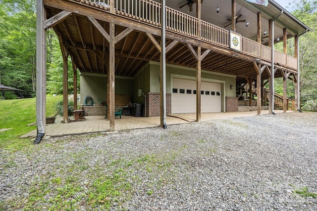 305 Pound Mill Branch Rd, Green Mountain, NC 28740 - view of front of home featuring an attached garage, a deck, driveway, ceiling fan, and brick siding