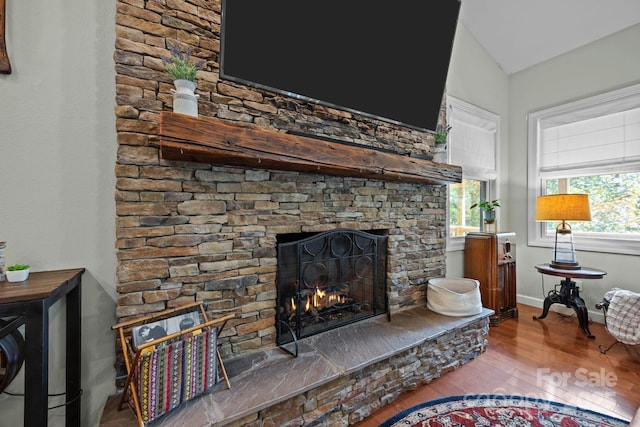 305 Pound Mill Branch Rd, Green Mountain, NC 28740 - detailed view of wood finished floors, a stone fireplace, and baseboards