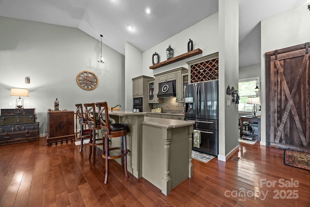305 Pound Mill Branch Rd, Green Mountain, NC 28740 - kitchen with black appliances, high vaulted ceiling, a kitchen breakfast bar, dark wood finished floors, and exhaust hood
