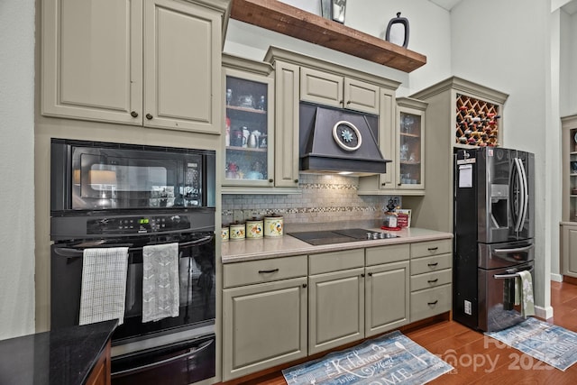 305 Pound Mill Branch Rd, Green Mountain, NC 28740 - kitchen with a warming drawer, black appliances, cream cabinetry, custom exhaust hood, and tasteful backsplash