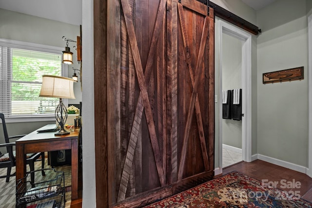 305 Pound Mill Branch Rd, Green Mountain, NC 28740 - detailed view of a desk, wood finished floors, a barn door, and baseboards