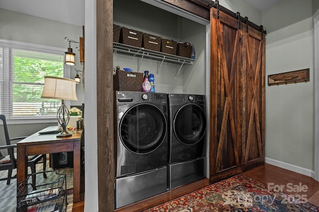 305 Pound Mill Branch Rd, Green Mountain, NC 28740 - laundry room with washing machine and clothes dryer, wood finished floors, a barn door, and baseboards