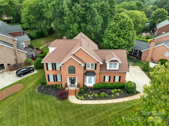 15737 Agincourt Dr, Huntersville, NC 28078 - view of front of home with a chimney, brick siding, concrete driveway, and a front lawn