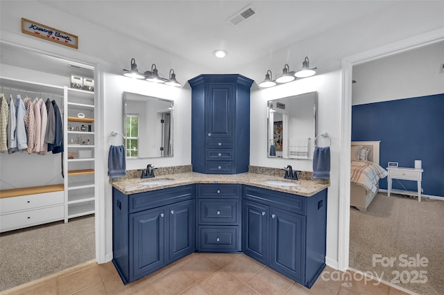 15737 Agincourt Dr, Huntersville, NC 28078 - bathroom with double vanity, tile patterned flooring, connected bathroom, a walk in closet, and recessed lighting