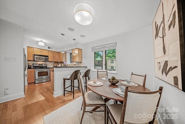 201 N Dotger Ave Unit C8, Charlotte, NC 28207 - dining area with light wood-style floors and baseboards