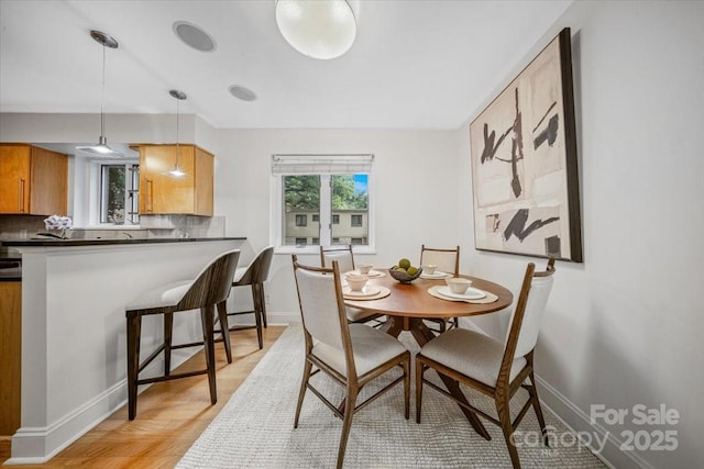 201 N Dotger Ave Unit C8, Charlotte, NC 28207 - dining space featuring baseboards and light wood-style flooring