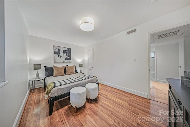 201 N Dotger Ave Unit C8, Charlotte, NC 28207 - bedroom with baseboards and light wood-style flooring