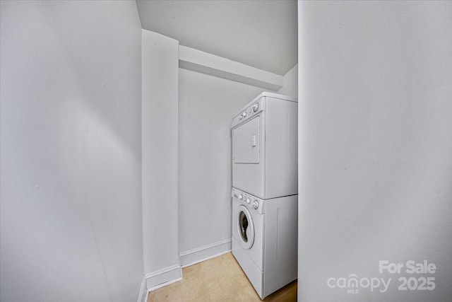201 N Dotger Ave Unit C8, Charlotte, NC 28207 - washroom featuring stacked washing machine and dryer, baseboards, and light floors