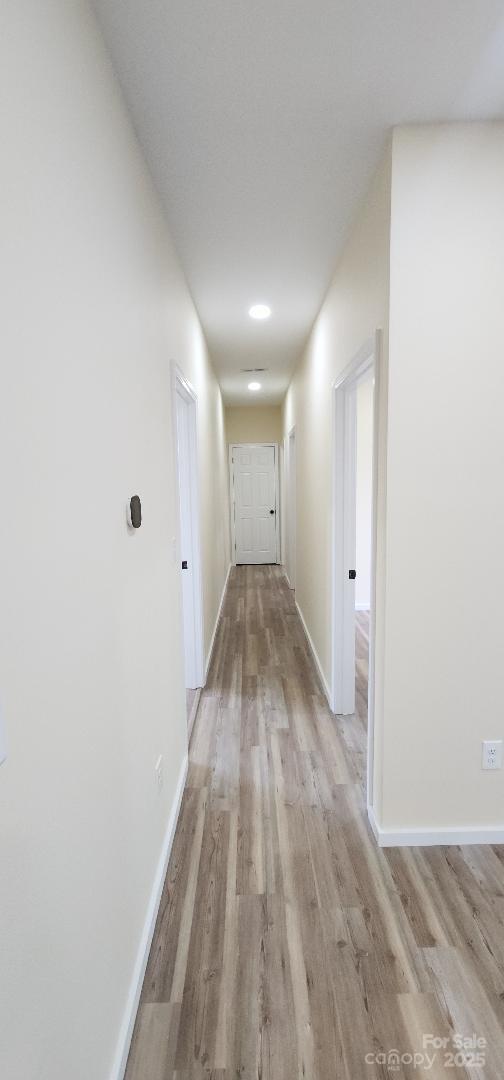 306 E Ratchford Ave, Gastonia, NC 28054 - corridor with light wood-style floors and baseboards