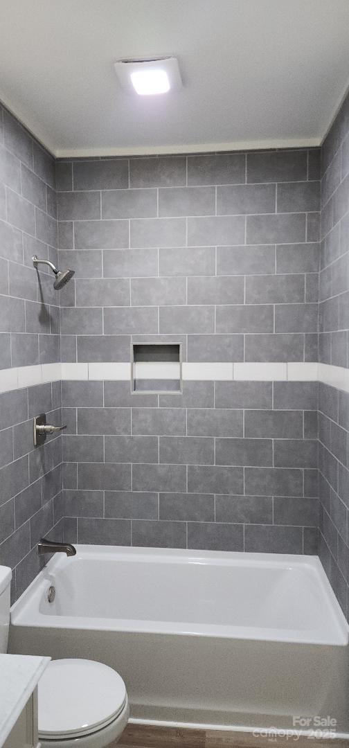 306 E Ratchford Ave, Gastonia, NC 28054 - bathroom with toilet, vanity, and bathing tub / shower combination