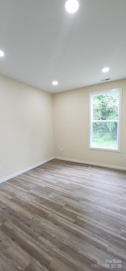 306 E Ratchford Ave, Gastonia, NC 28054 - spare room with recessed lighting, wood finished floors, and baseboards