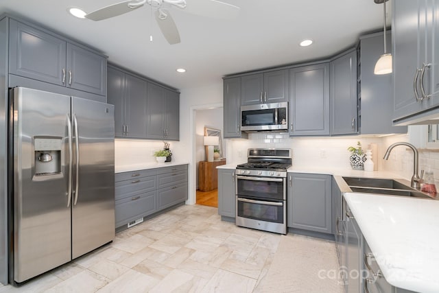 5424 Doncaster Dr, Charlotte, NC 28211 - kitchen featuring appliances with stainless steel finishes, a ceiling fan, gray cabinets, light countertops, and backsplash