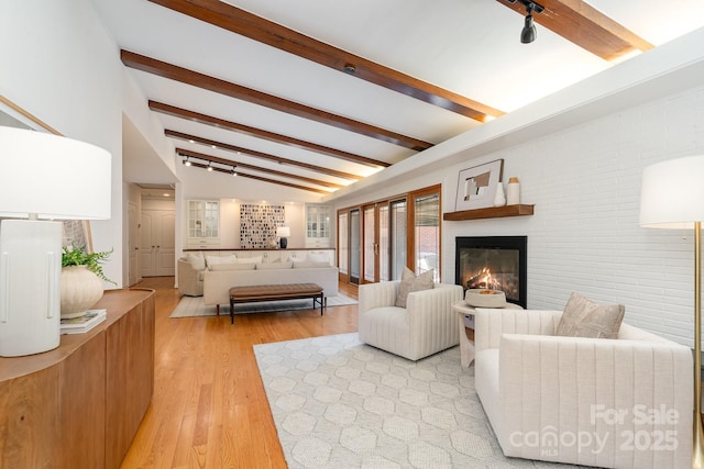 5424 Doncaster Dr, Charlotte, NC 28211 - living area with a glass covered fireplace, light wood-type flooring, and brick wall