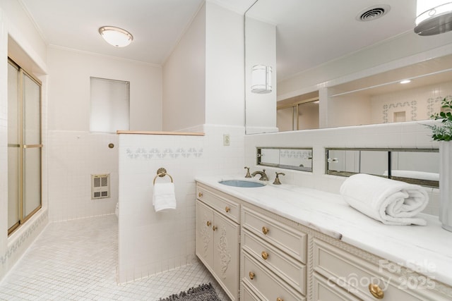 5424 Doncaster Dr, Charlotte, NC 28211 - full bathroom featuring an enclosed shower, vanity, tile patterned floors, ornamental molding, and tile walls