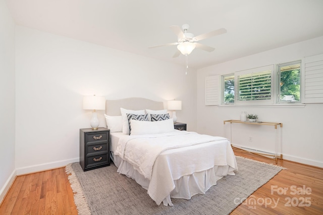 5424 Doncaster Dr, Charlotte, NC 28211 - bedroom featuring light wood finished floors, a baseboard heating unit, and a ceiling fan